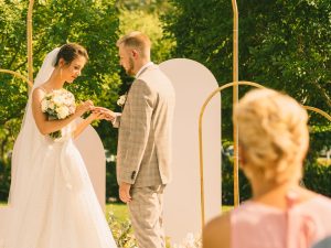 pexels-photo-9721887-9721887 | ATZ Why Settle? Bride and groom exchange rings during a beautiful outdoor wedding ceremony.